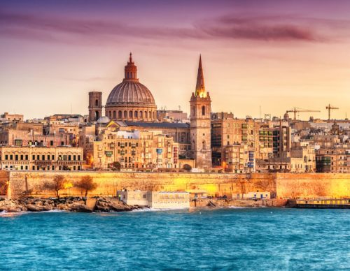 Valletta, Malta: skyline from Marsans Harbour at sunset. The cathedral